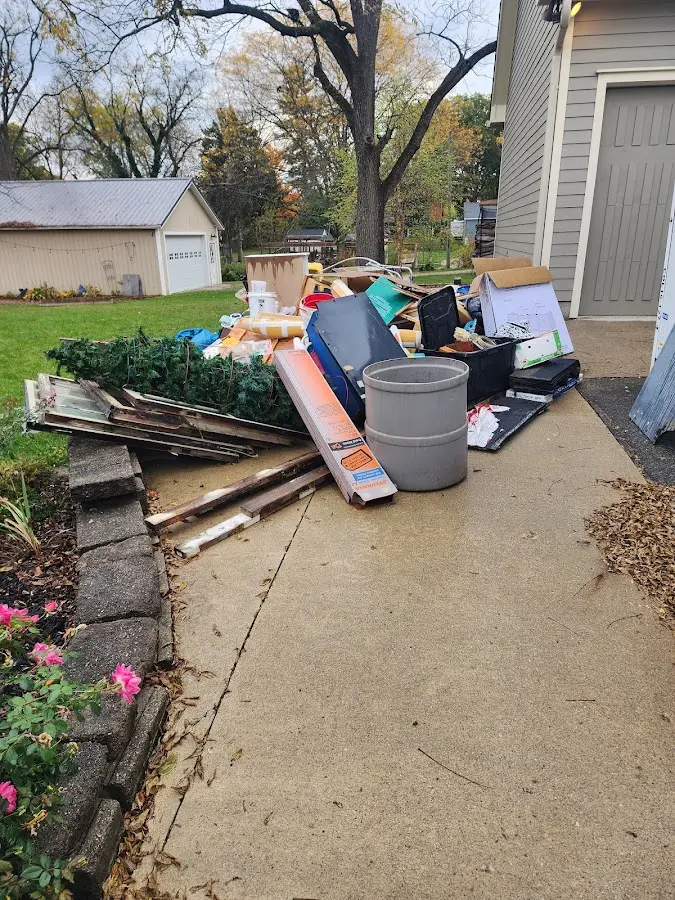 Dumpster being loaded with debris for Estate Cleanout Dumpster Rental in Midway